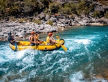 a group of people riding on the back of a raft