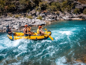 a group of people riding on the back of a raft