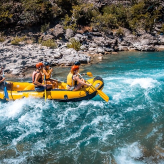 a group of people riding on the back of a raft