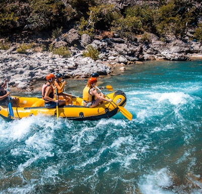 a group of people riding on the back of a raft