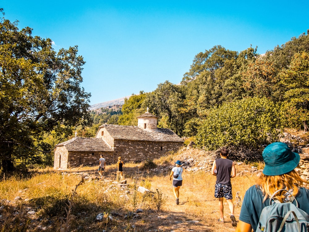 a group of people walking down a dirt road