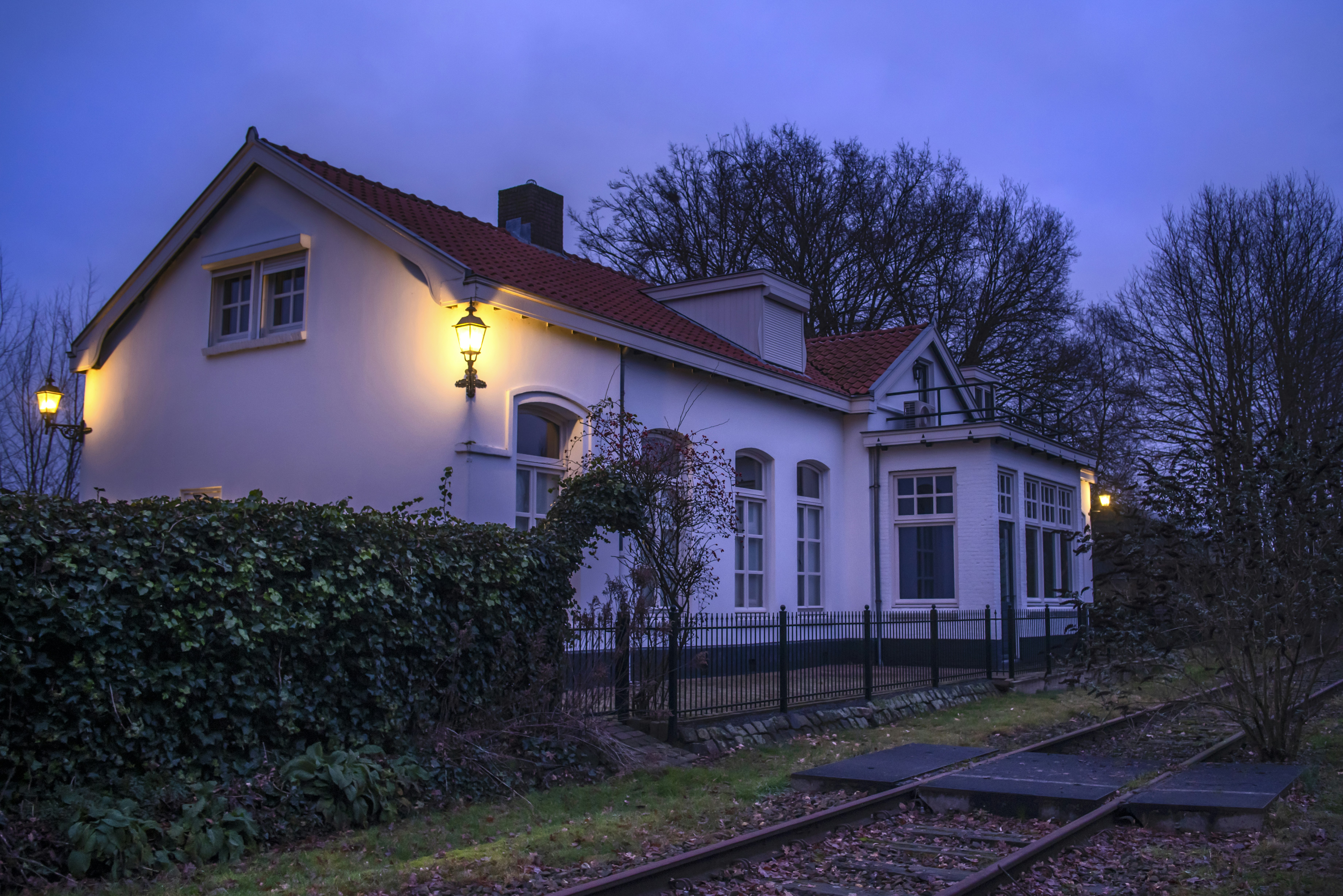 a white house sitting next to a train track