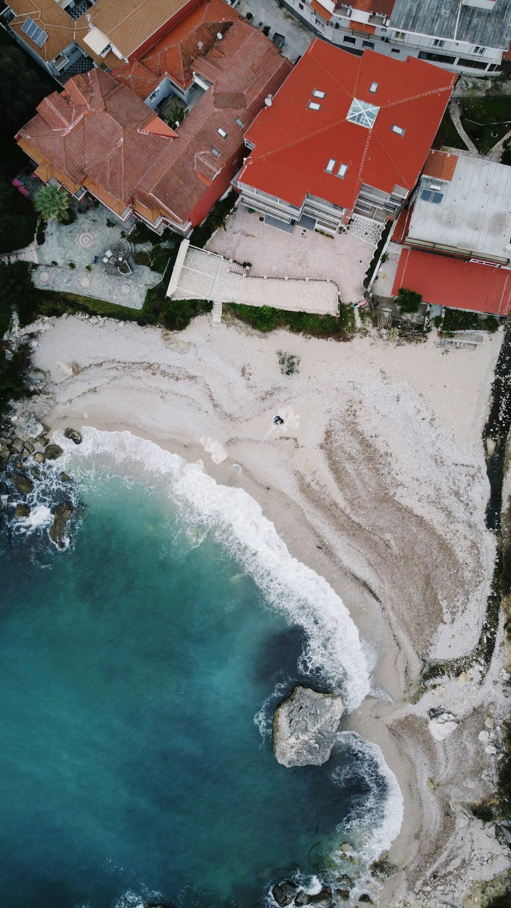 an aerial view of a beach next to a city