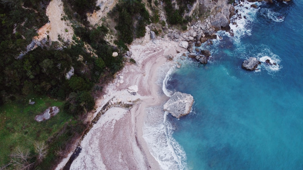 an aerial view of a beach and a cliff