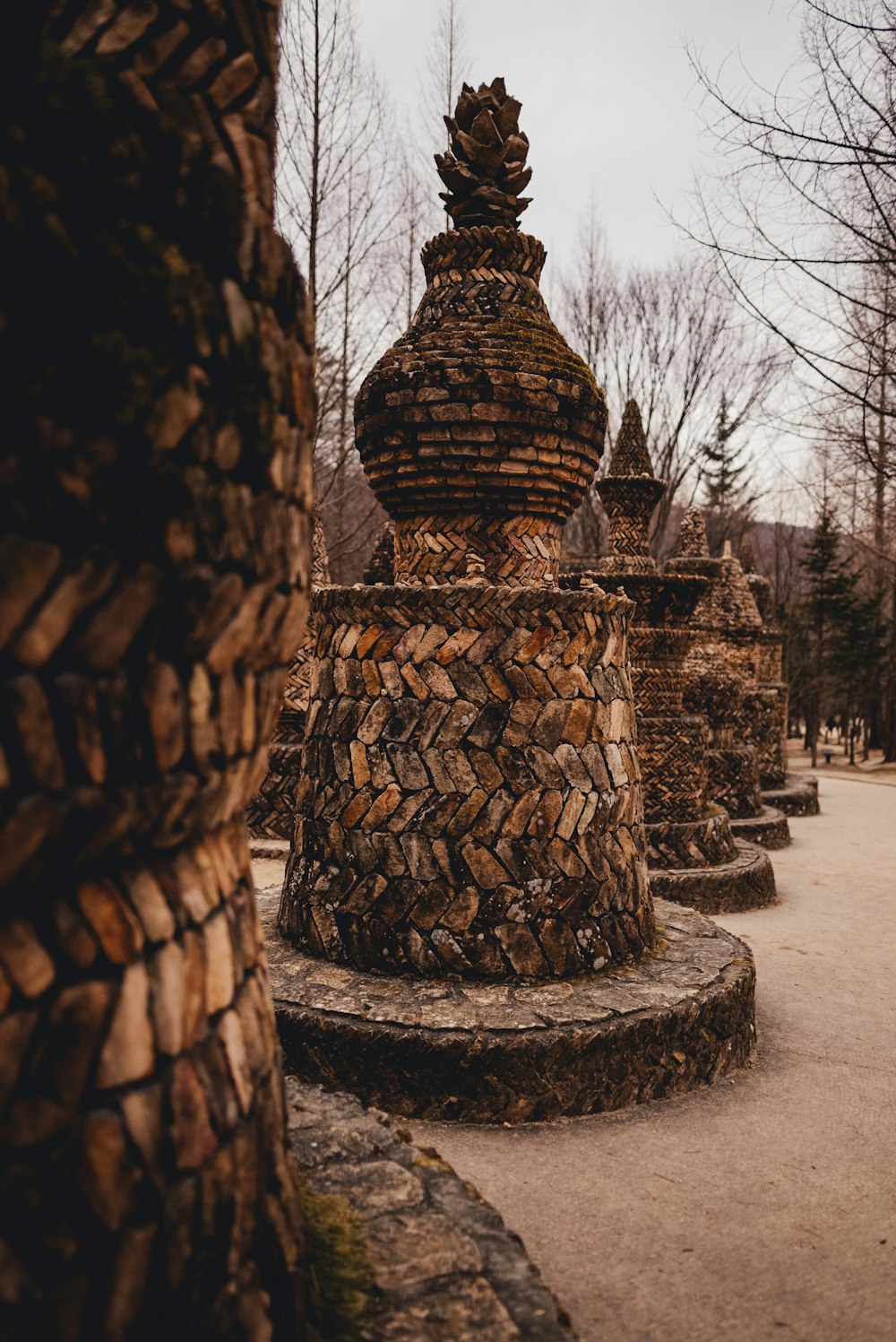 a stone structure with a tree in the background