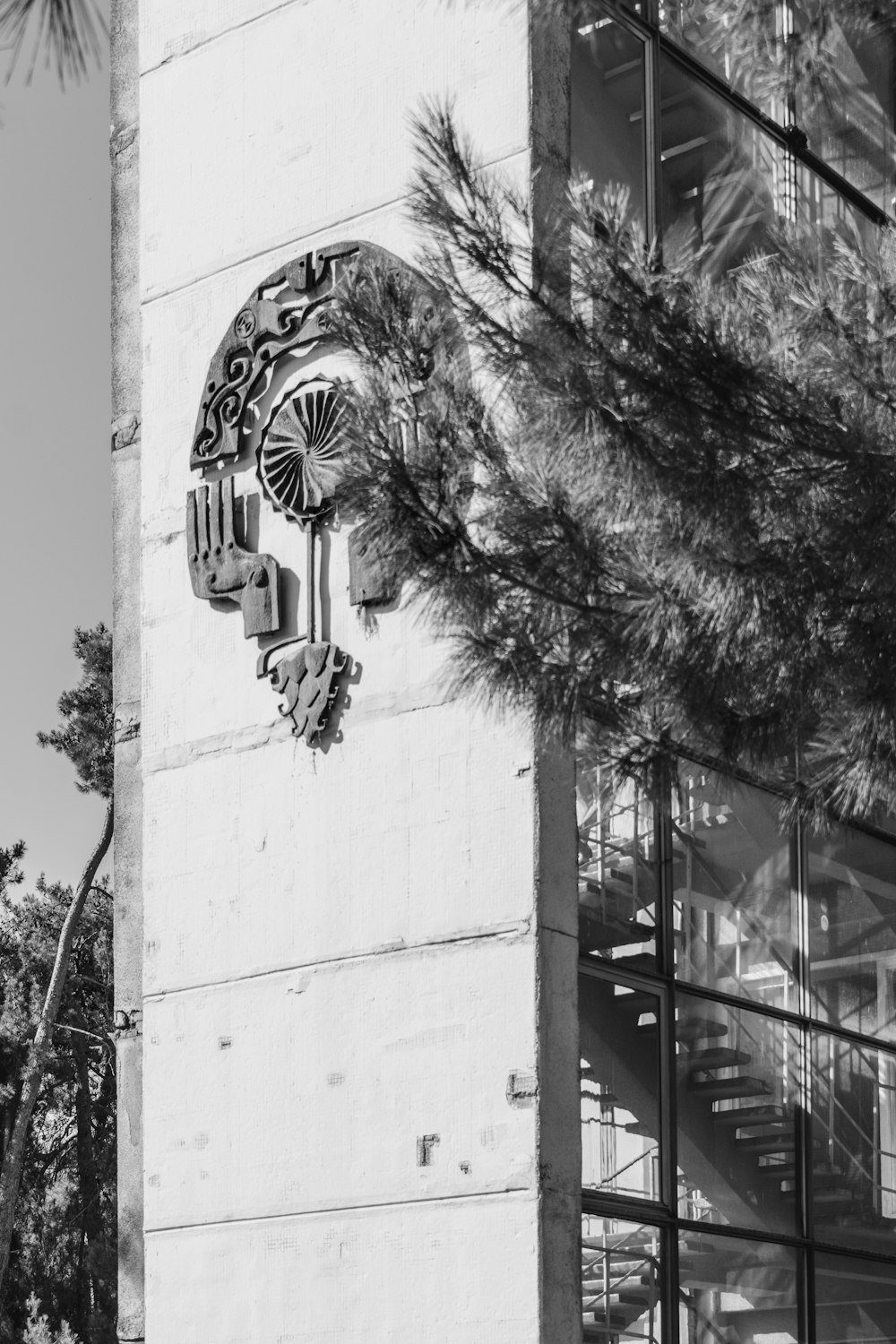 a black and white photo of a clock on the side of a building