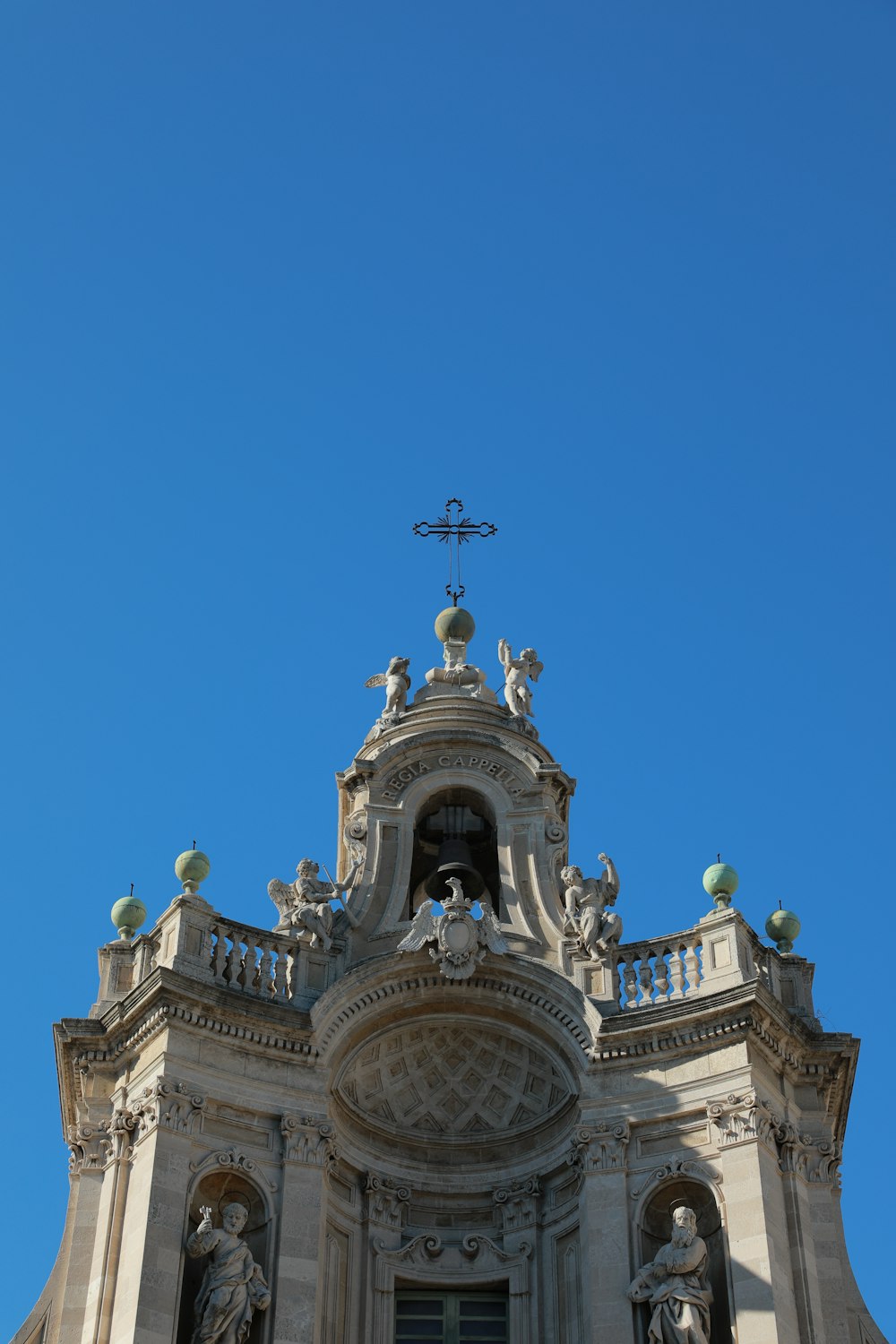 the top of a building with statues on it