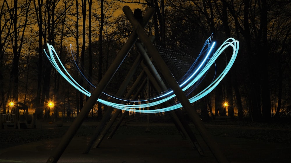 a sculpture with lights in the dark in a park