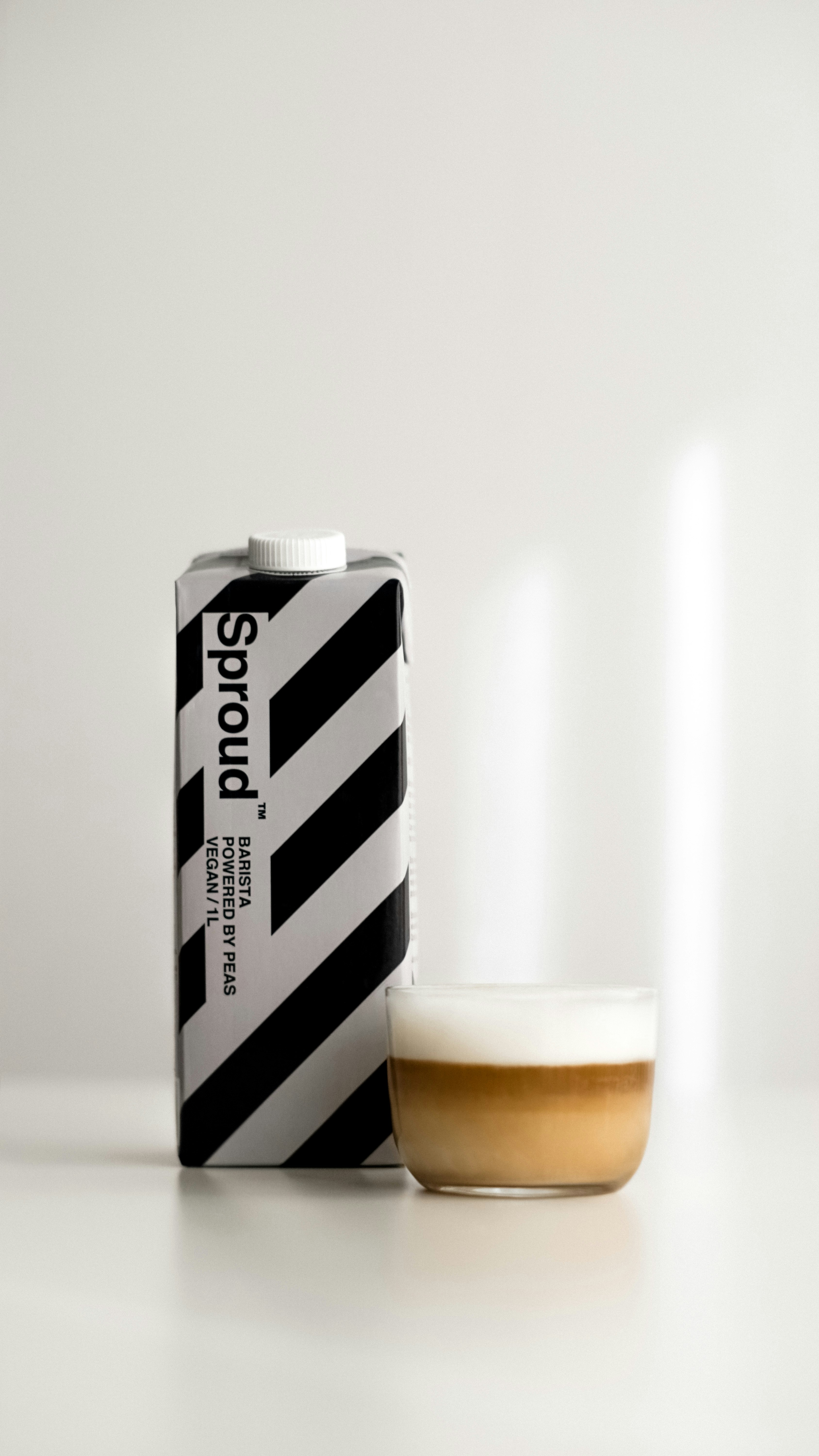 a can of beer next to a glass of beer