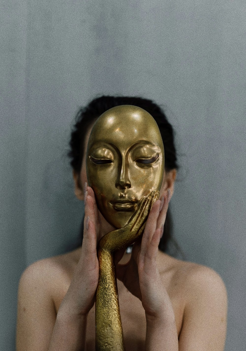 a woman with a gold mask covering her face