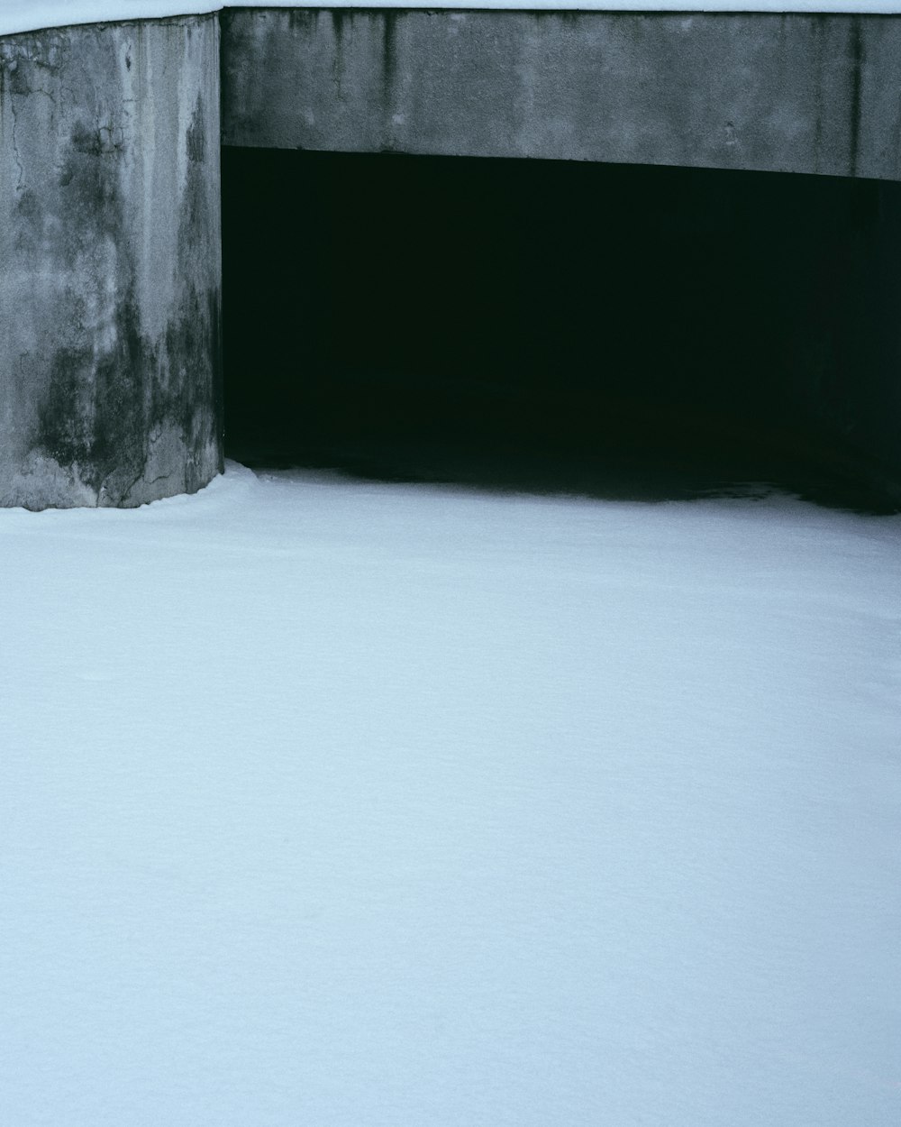 a snow covered ground with a tunnel in the middle