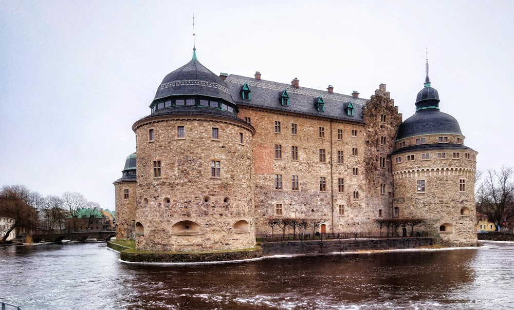 a large castle sitting on top of a river