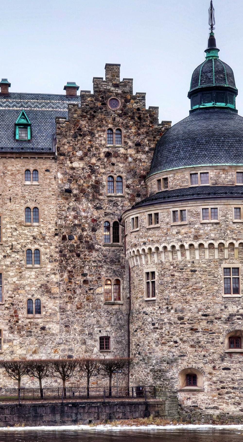 a large stone building with a clock on the top of it