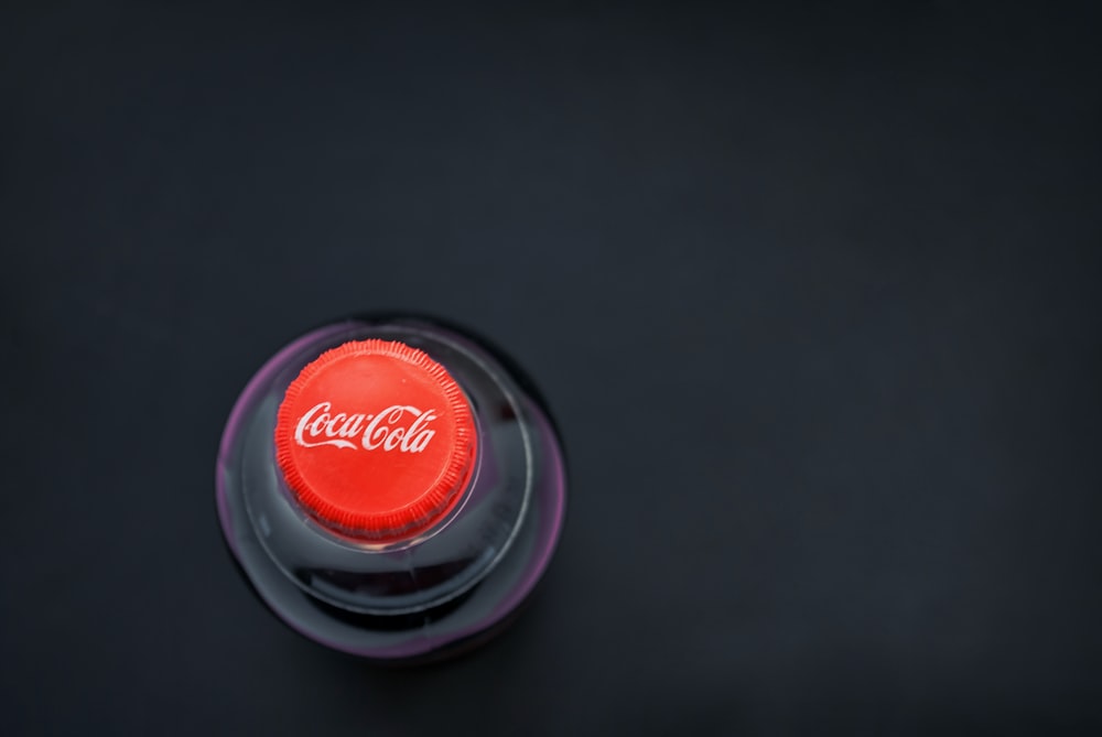 a close up of a bottle cap on a black surface