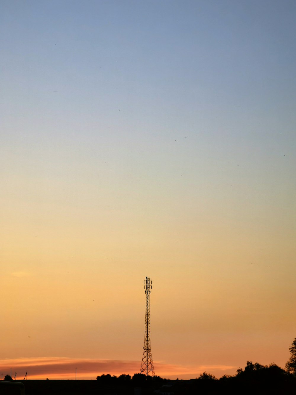 an airplane is flying in the sky at sunset