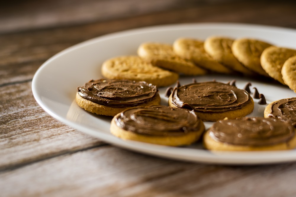 a white plate topped with cookies and chocolate frosting