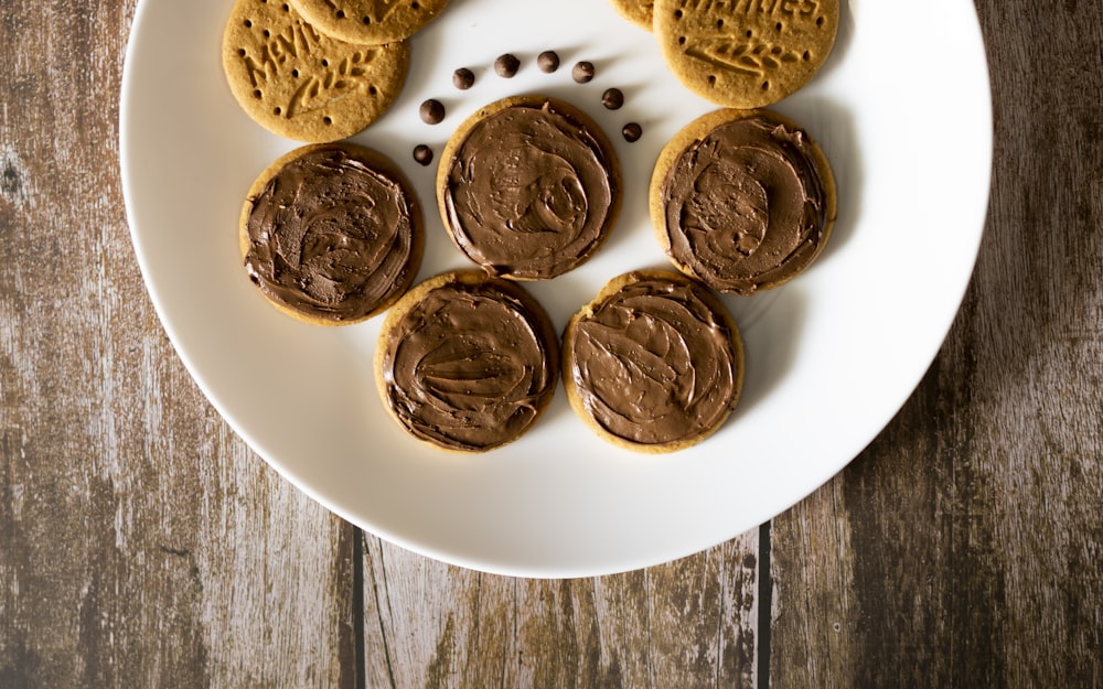 a white plate topped with cookies covered in frosting