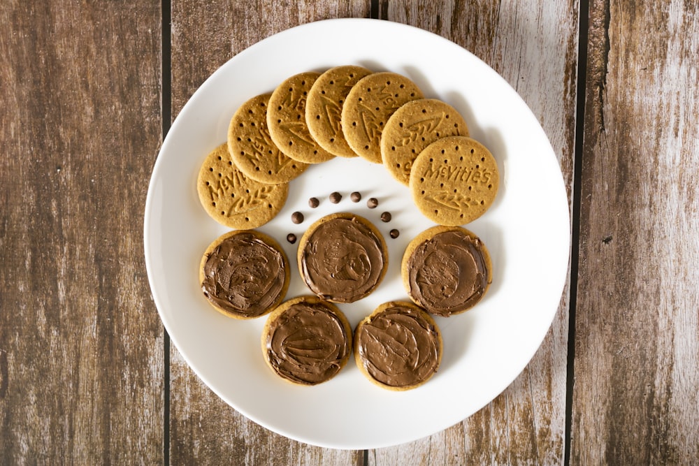 a white plate topped with cookies and peanut butter