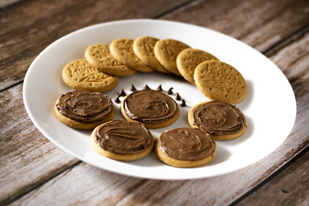 a white plate topped with cookies and chocolate frosting