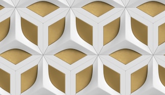 a white and gold wall with a geometric pattern