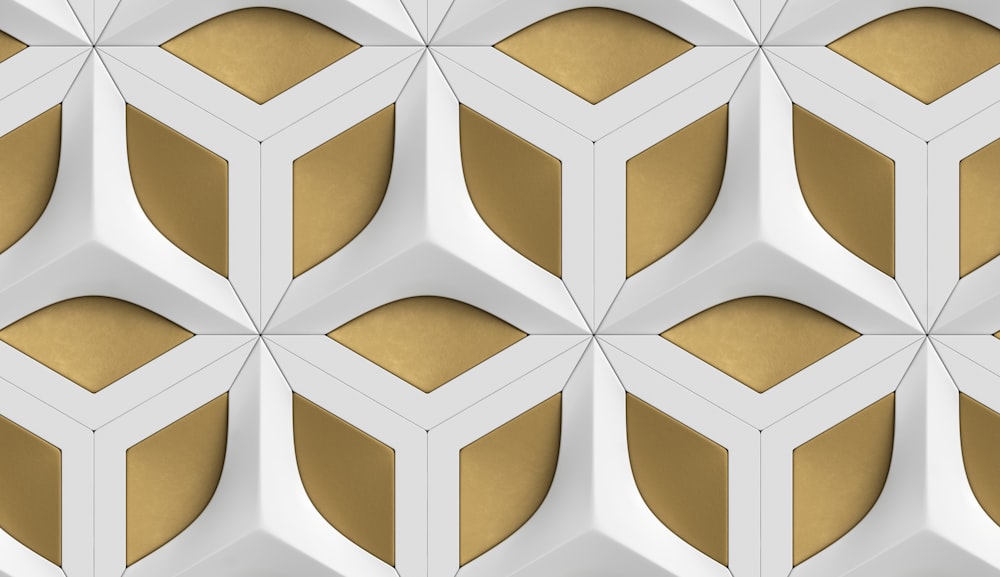 a white and gold wall with a geometric pattern