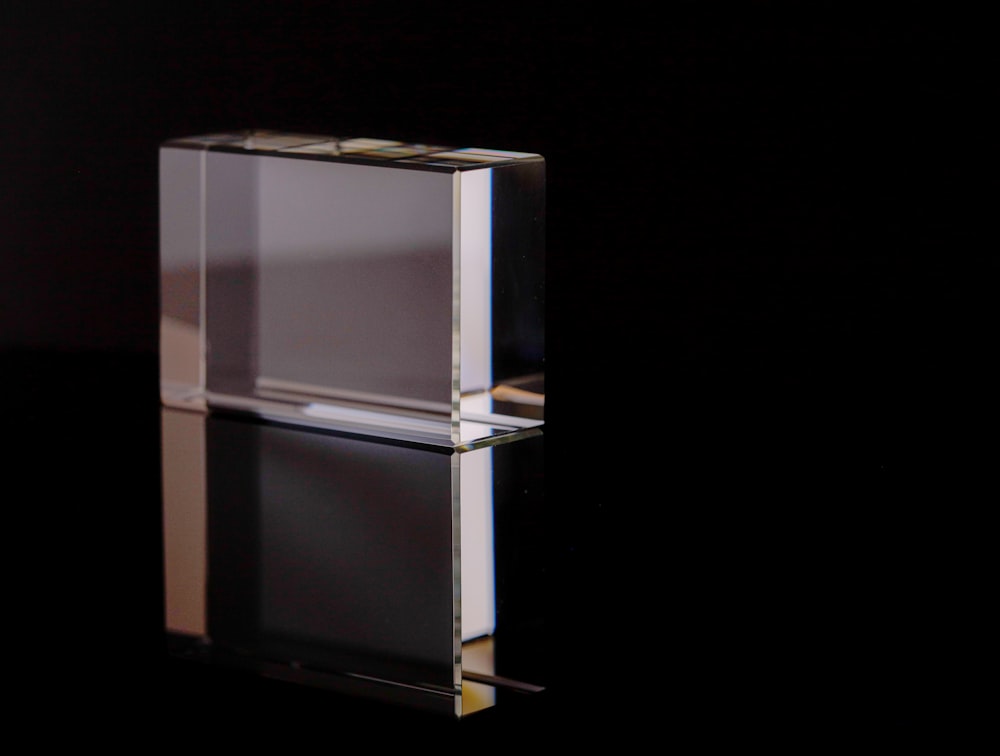 a clear glass object on a black background
