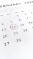a close up of a calendar with a red marker