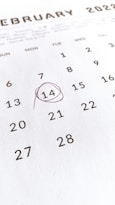 a close up of a calendar with a red marker