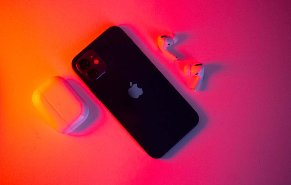 an iphone and ear buds on a table