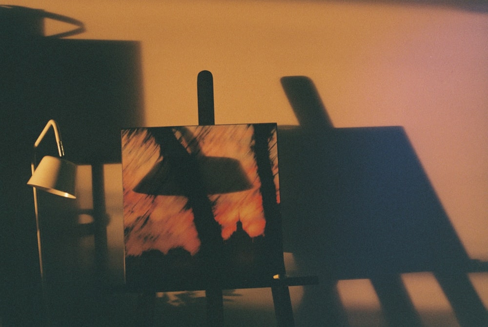 a picture of a lamp and a painting on a table