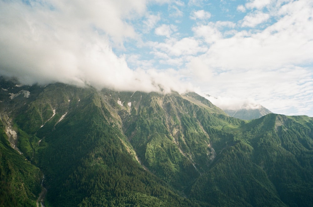 a view of the top of a mountain covered in clouds