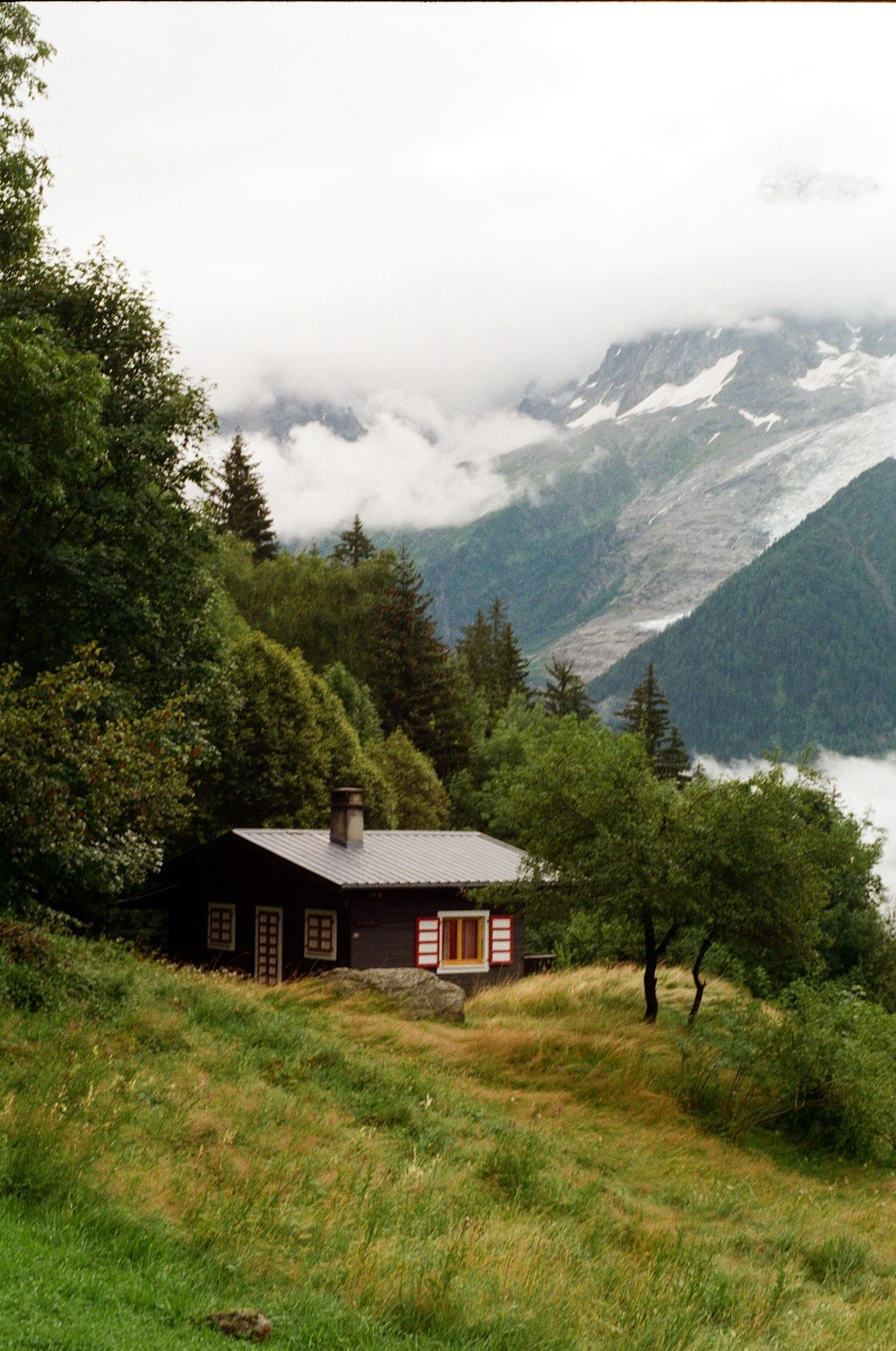 a cabin in the mountains with a view of a lake