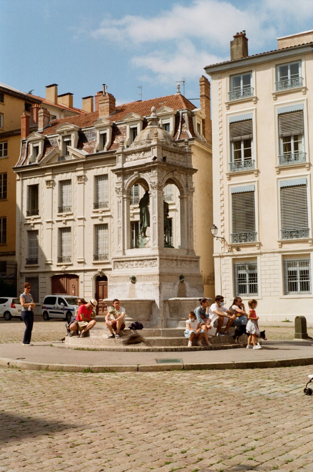 a group of people sitting on a bench in front of a building