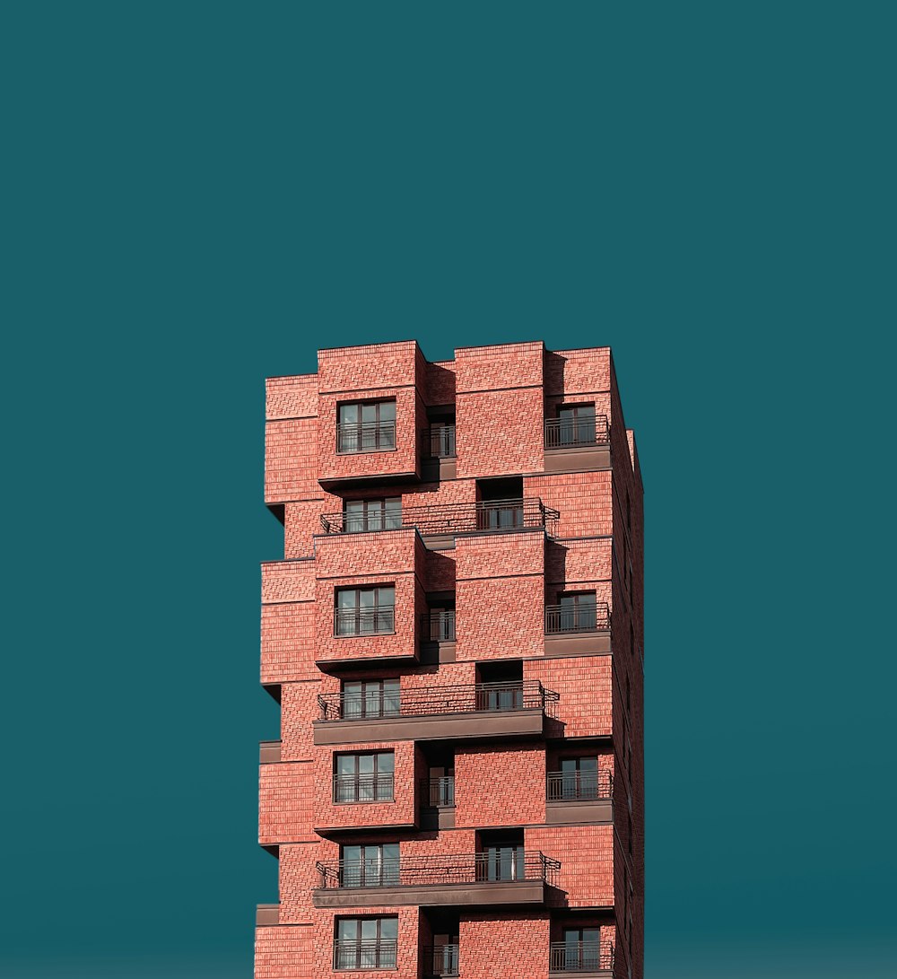a tall red brick building with balconies