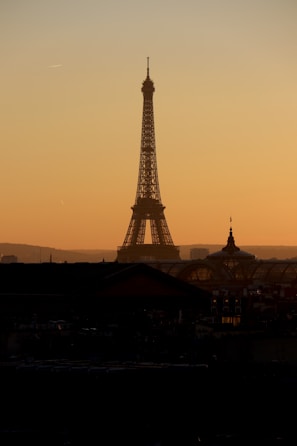A realistic photo of the Eiffel Tower at sunset with warm light.