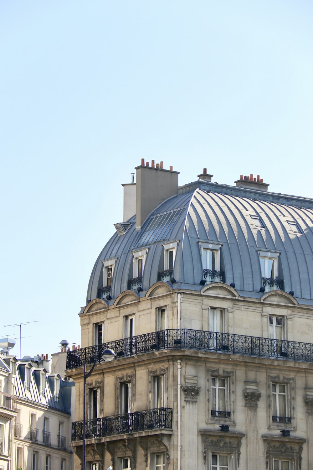 a tall building with a blue roof and a clock on it