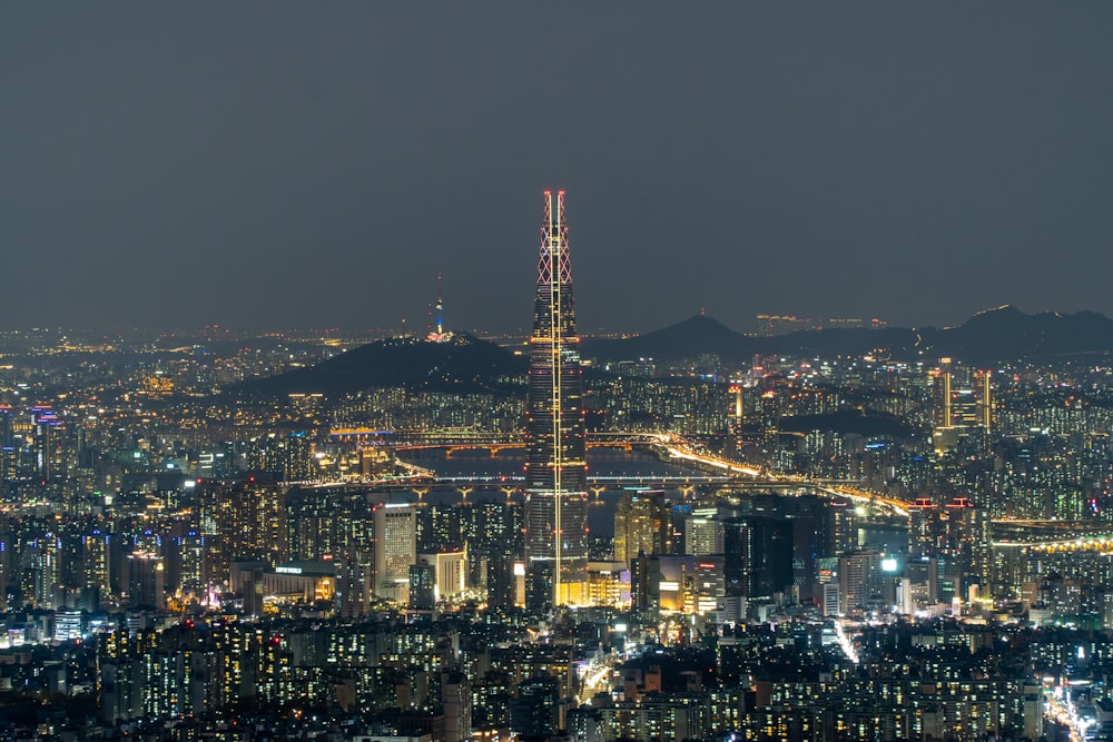 a view of a city at night from the top of a hill