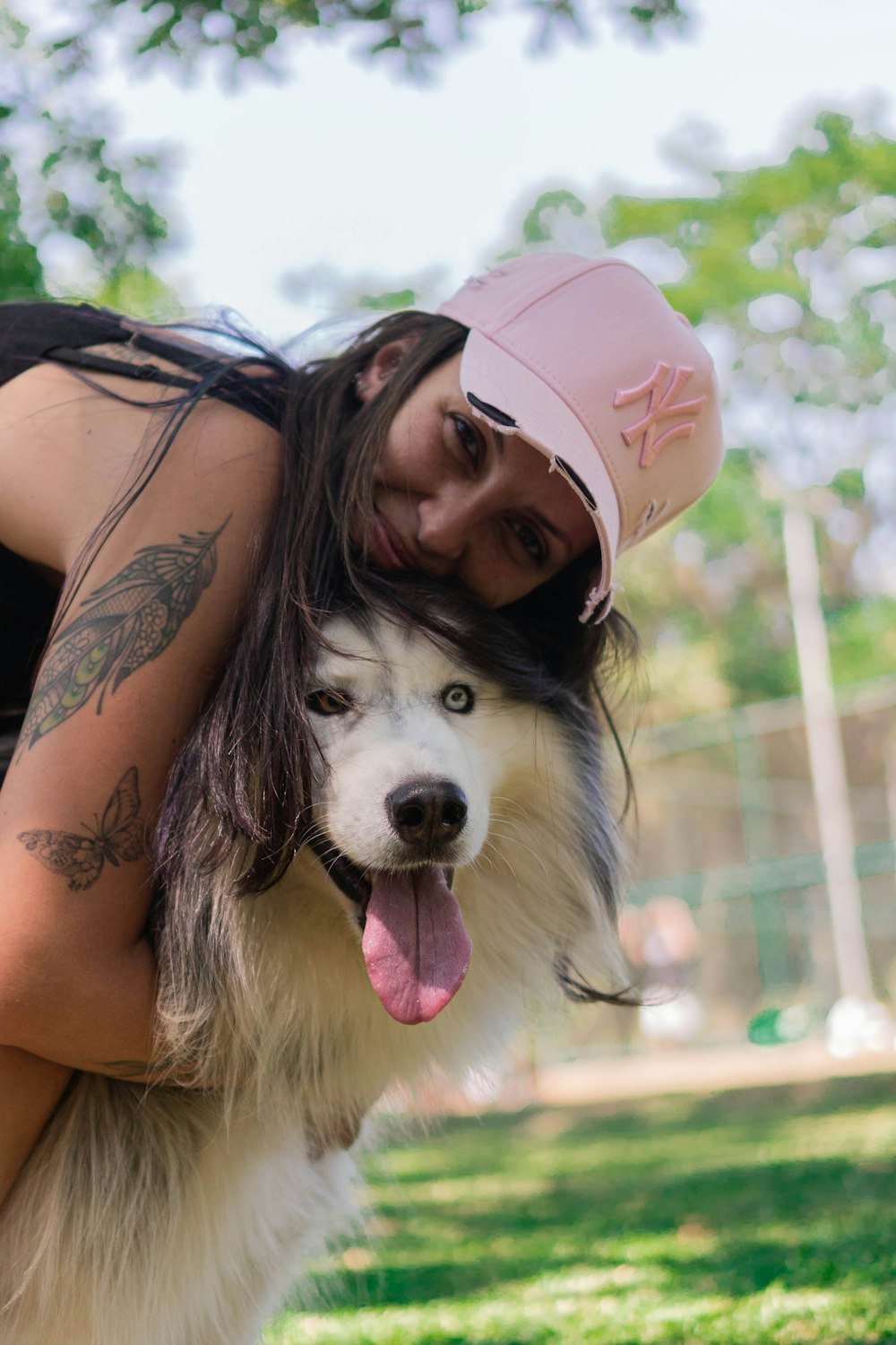 a woman hugging a dog in a park