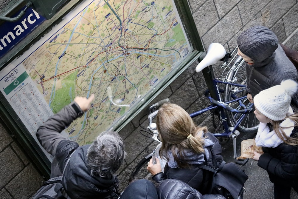 a group of people looking at a map