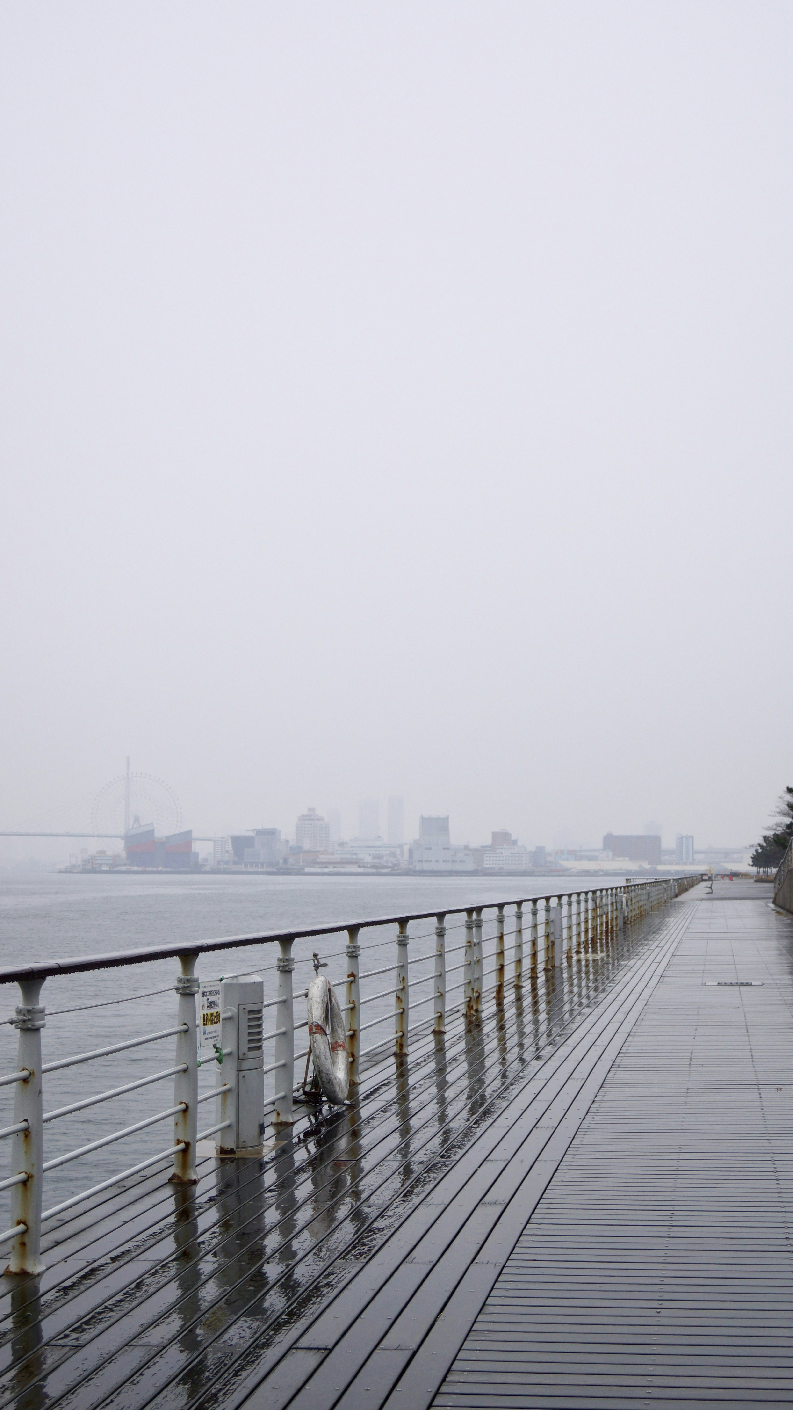 A person riding a bike on a bridge over water photo – Free Railing ...