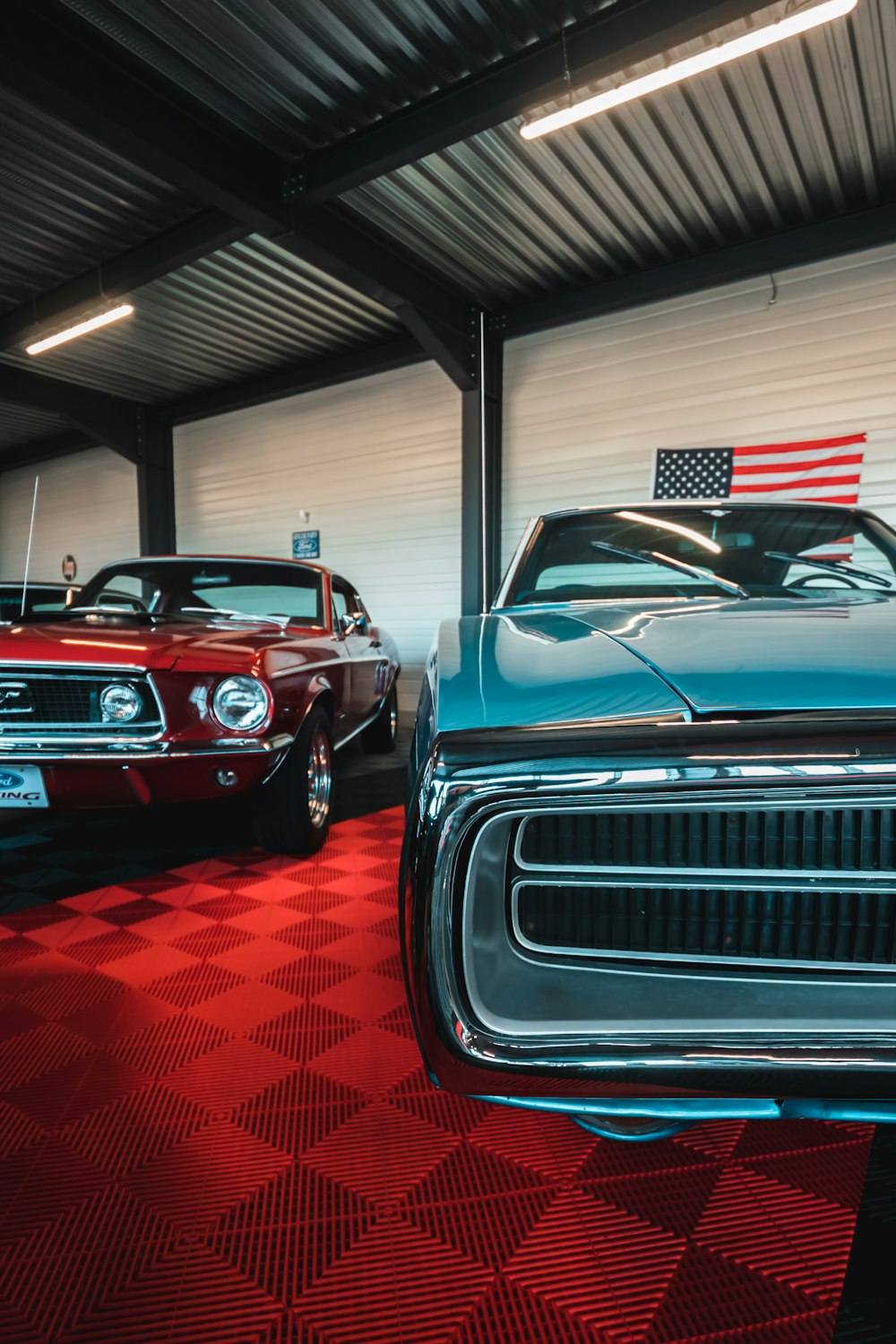 a couple of cars are parked in a garage