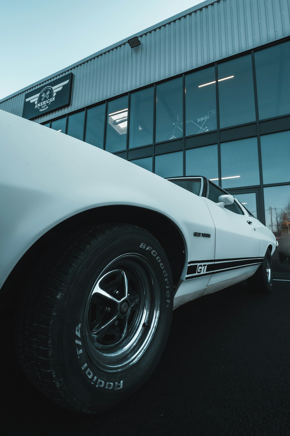 a white car parked in front of a building