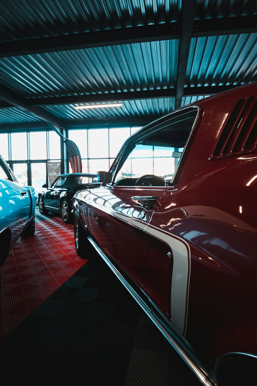 a group of cars parked inside of a garage