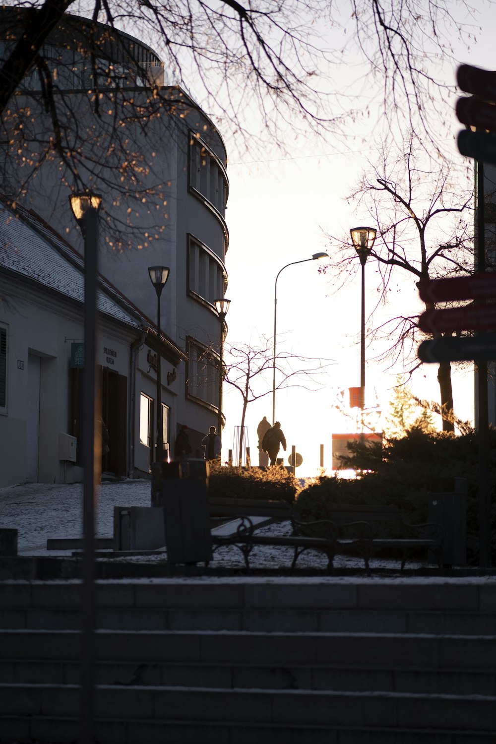 a couple of people walking down a street