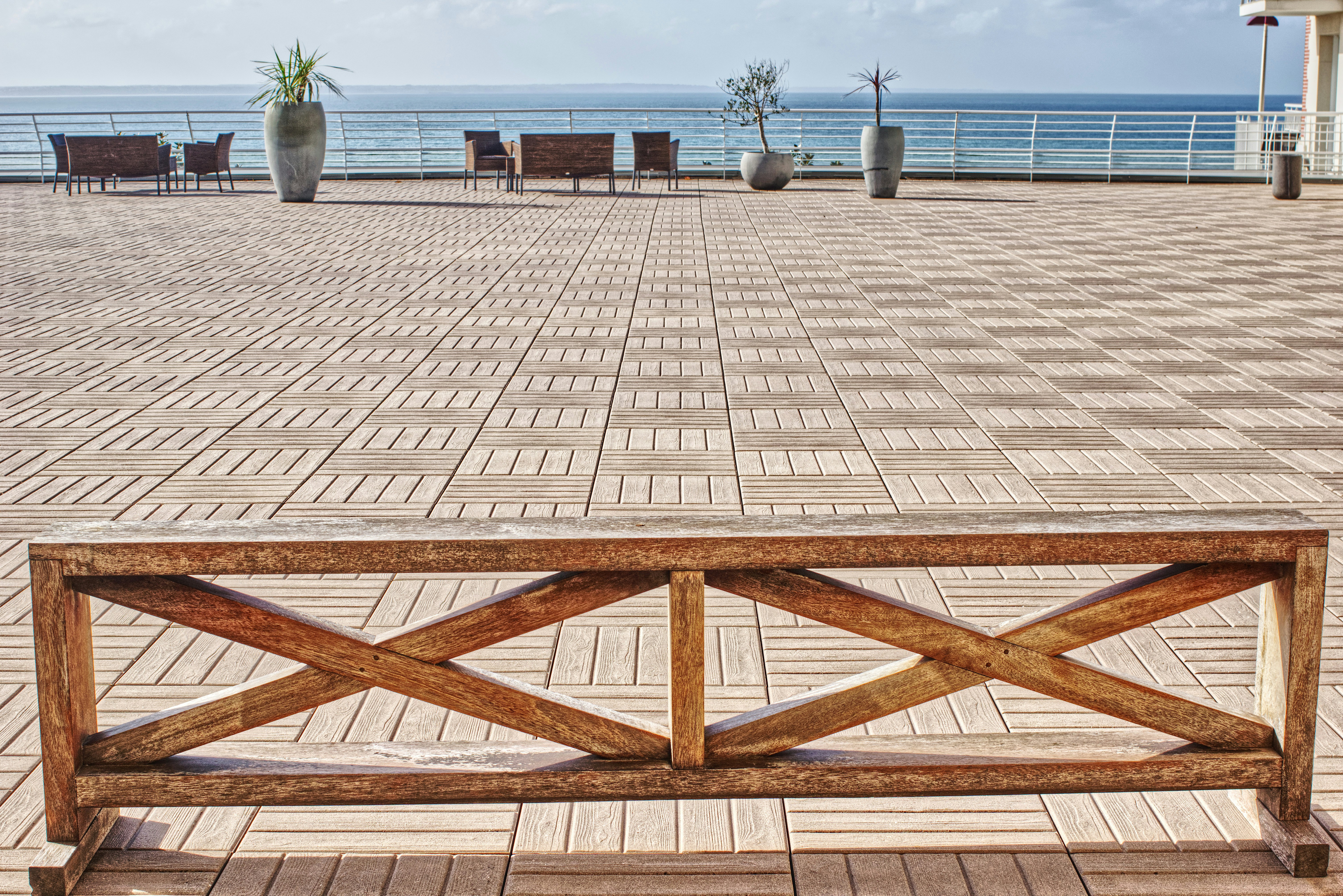 a wooden bench sitting on top of a brick walkway