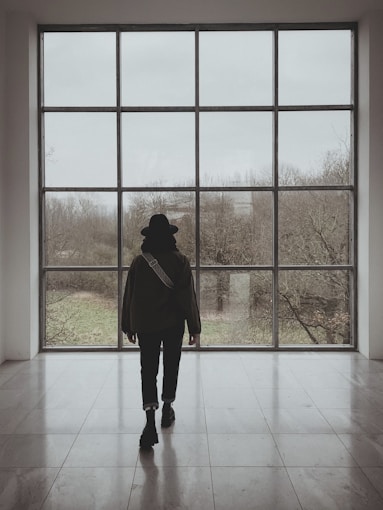 a person standing in front of a large window