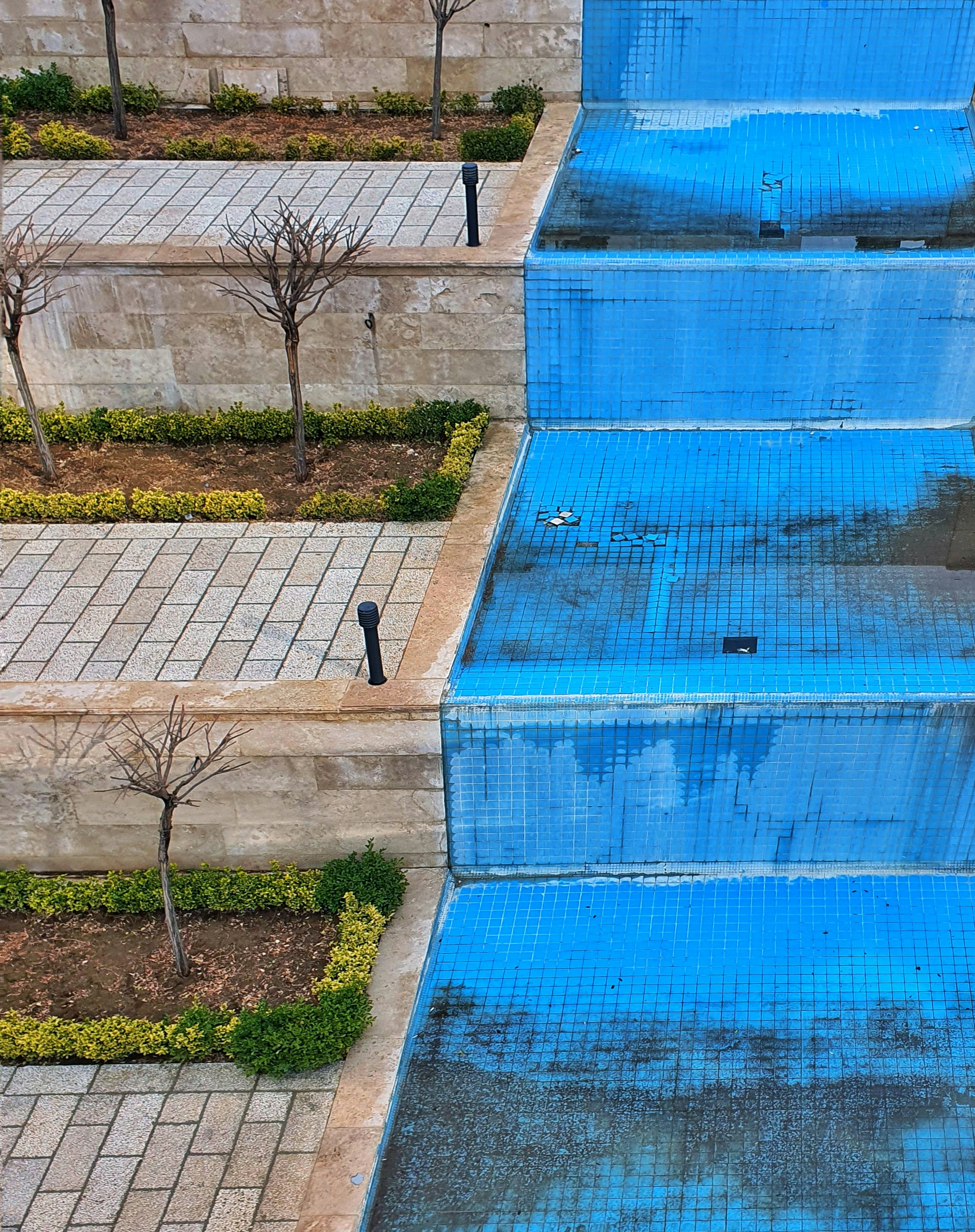 a blue set of steps leading up to a pool