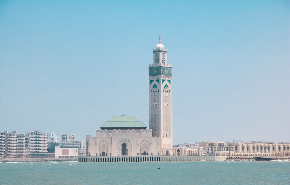 a large white building with a green roof