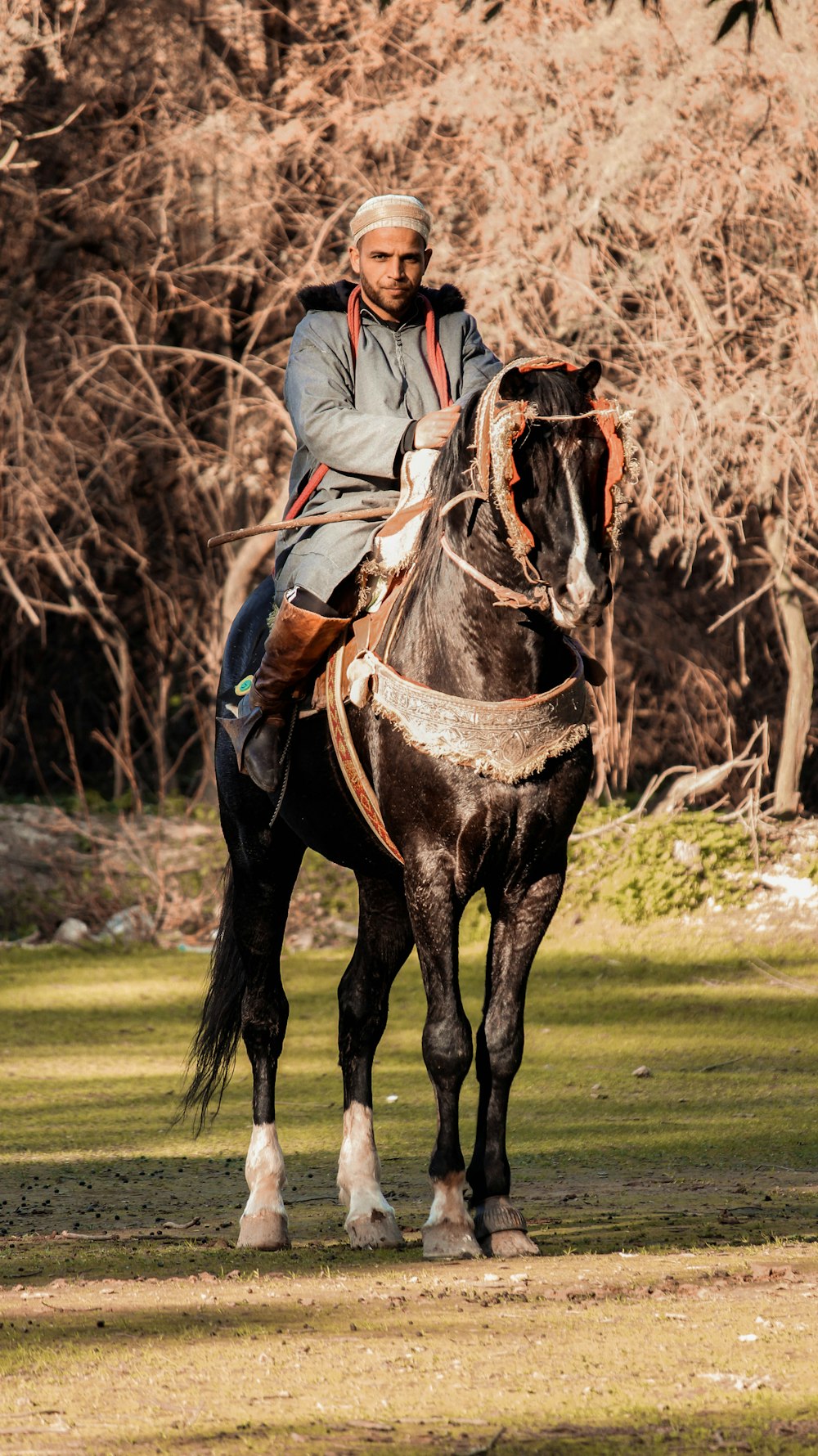 a man riding on the back of a black horse