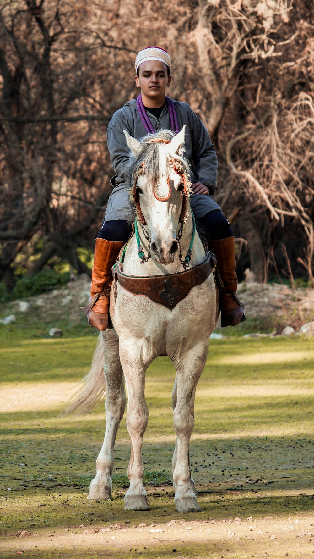 a man riding on the back of a white horse